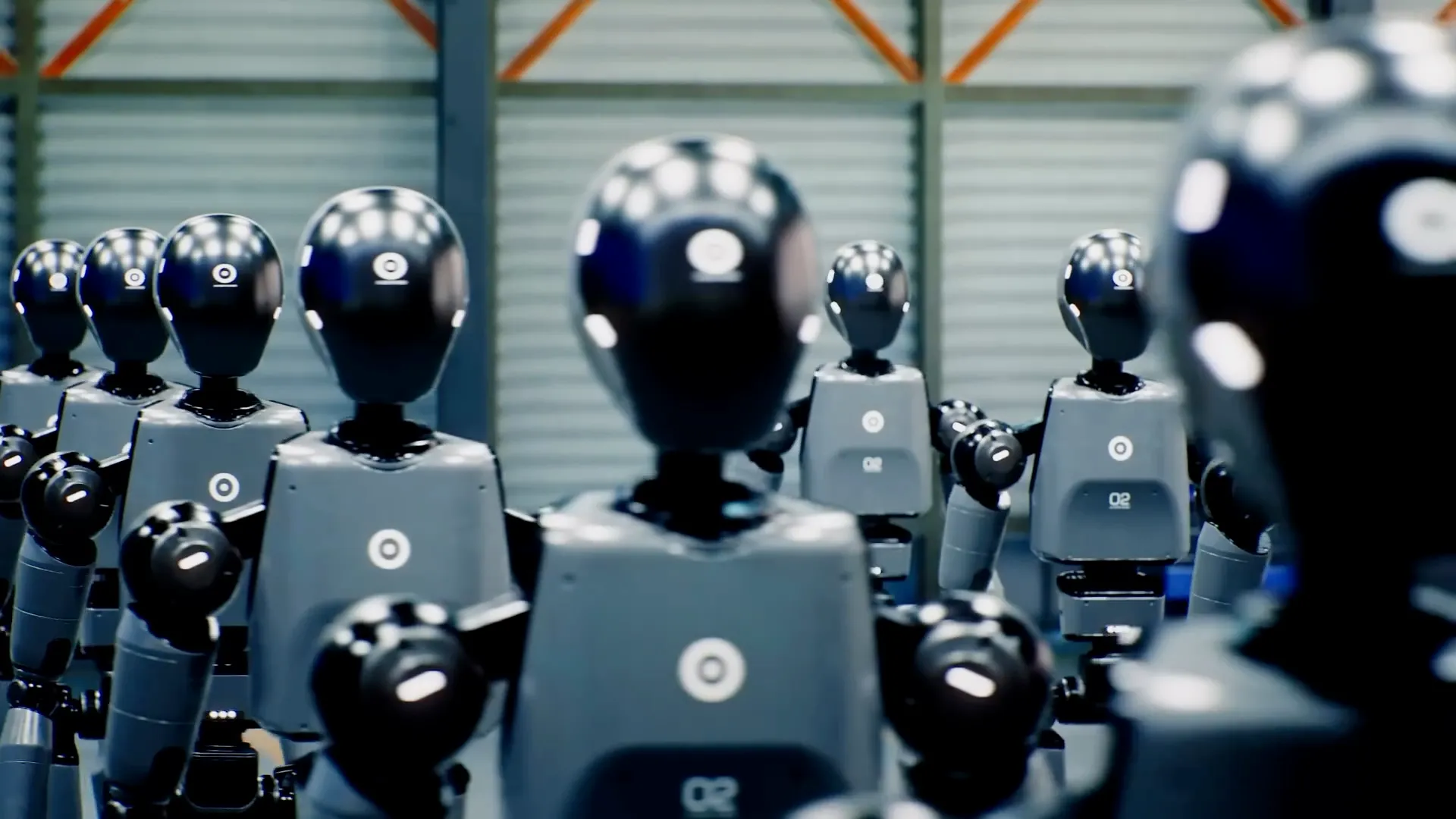 Ranks of identical black-and-white humanoid robots standing in a factory hall.