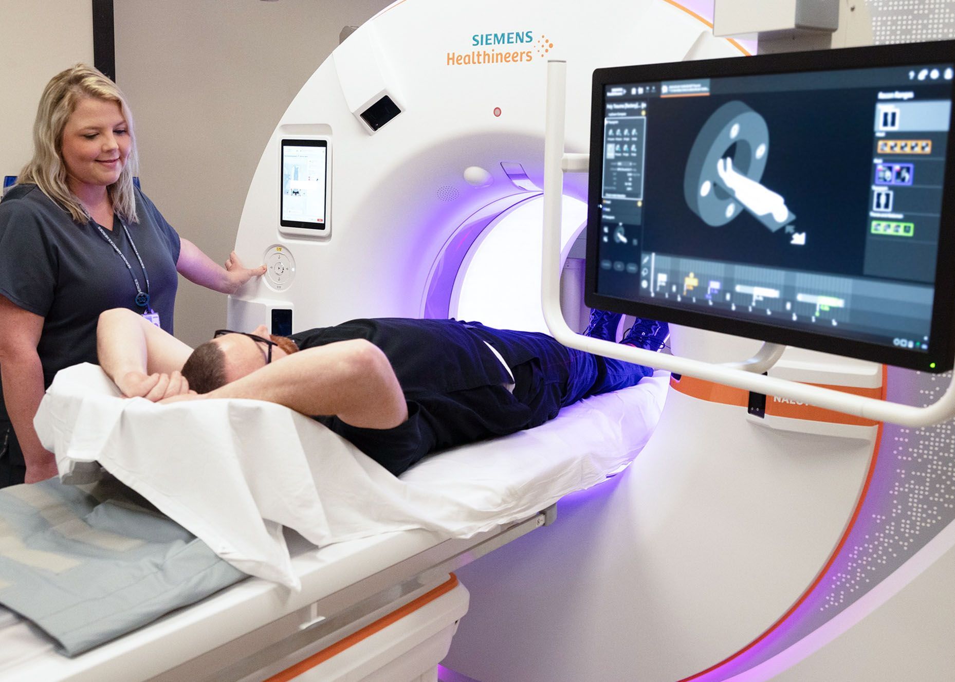 CT Technician, Amber Kendrick, uses NAETOM Alpha at Birmingham VA. This AI-driven imaging technology helps radiologists perform safer, more accurate scans that reduce patient exposure to radiation and advances early diagnosis. (Image by Birmingham VA.)