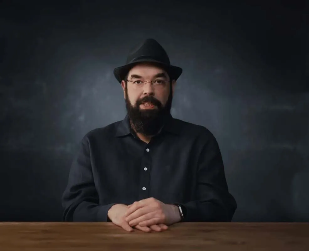 Eliezer Yudkowsky seated at a table in an interview setting.