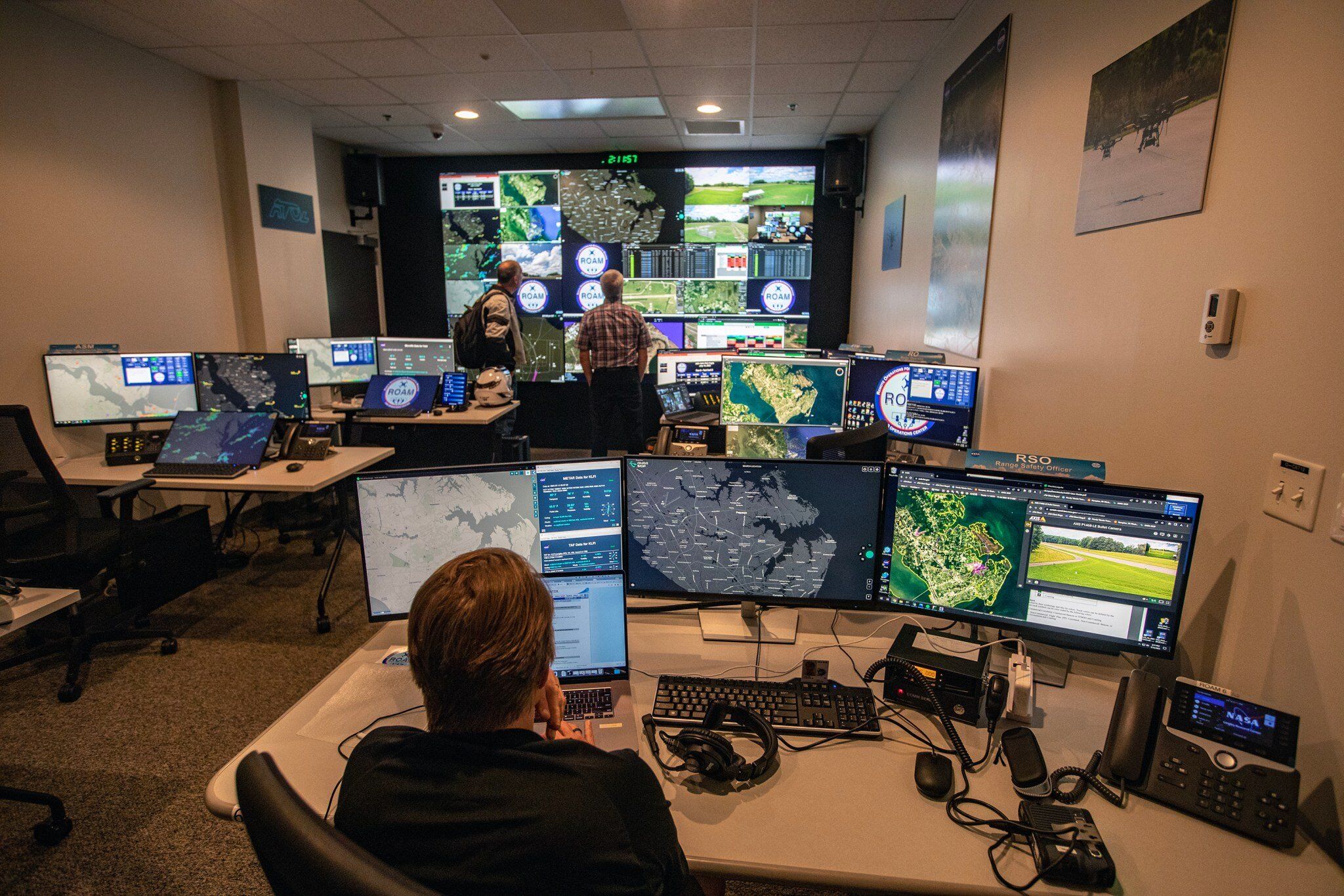 Human operators monitoring AI-assisted systems in a control room